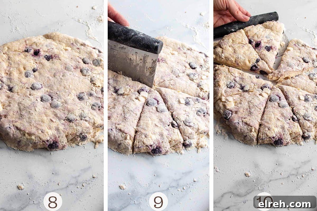 Flaky Sourdough Blueberry Scones Recipe 6 A disc of sourdough scone dough and a bench scraper cutting it into triangles.