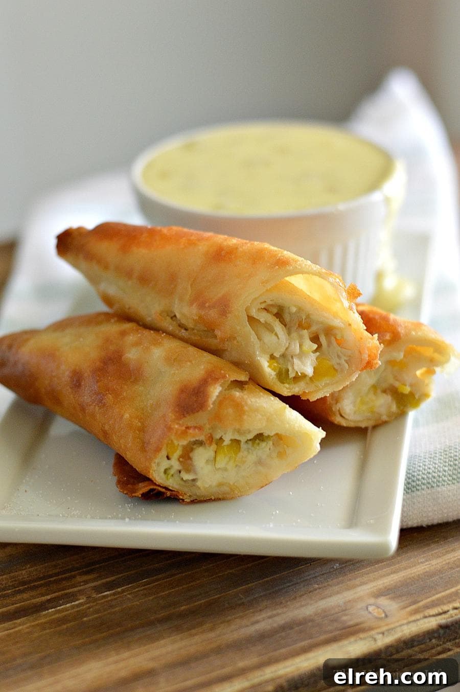 Rolled Tacos with Spicy Queso Sauce Rolled Tacos on a plate with queso