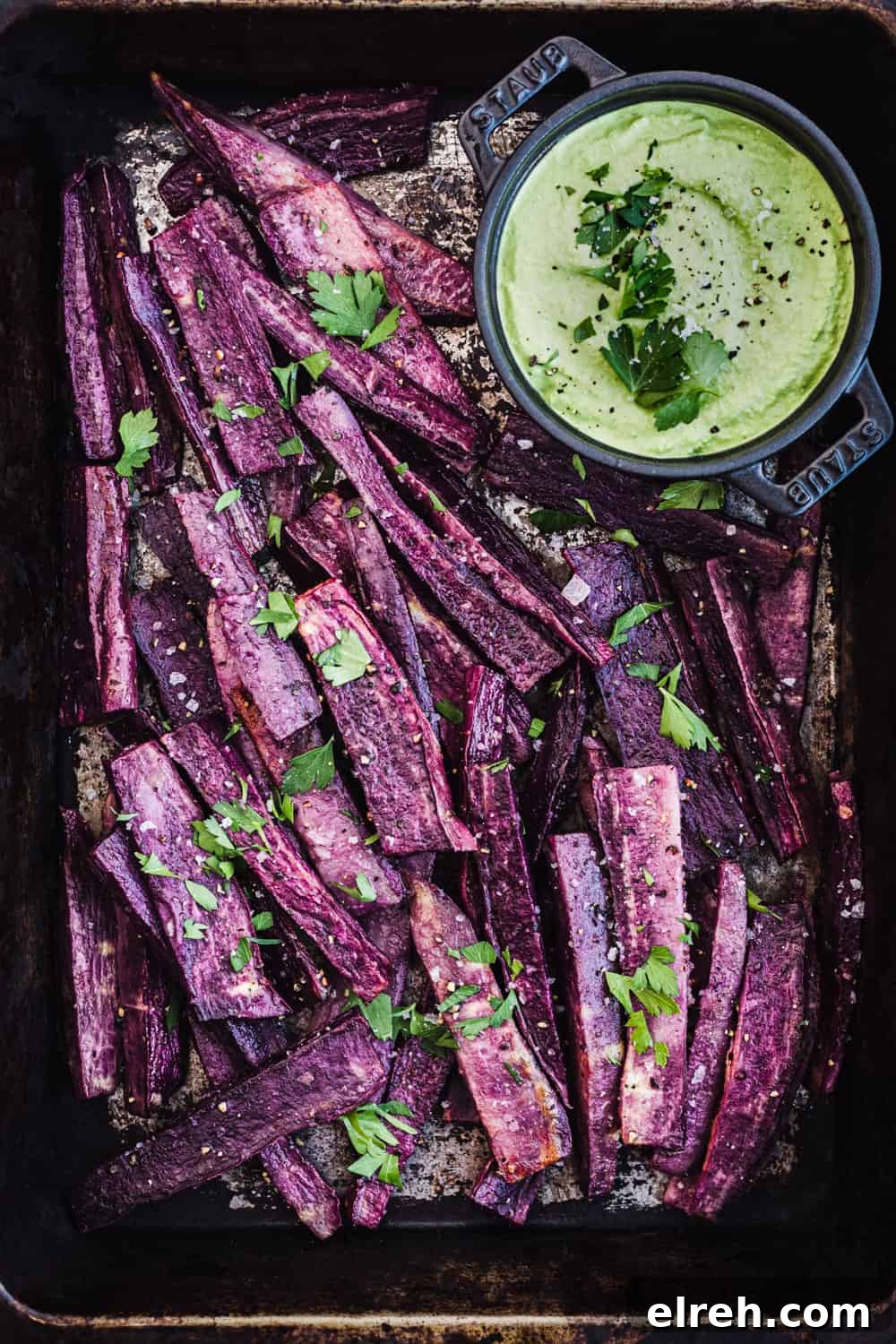sweet potato fries with a dip and parsley, ready to be eaten