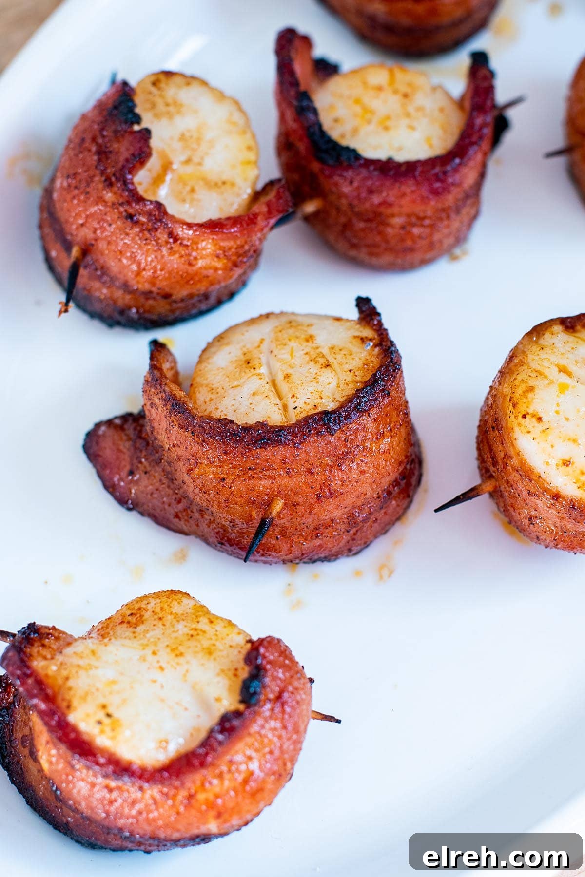 Sweet and Smoky Bacon Wrapped Scallops 2 Perfect golden brown bacon-wrapped scallops with slight charred bacon edges.