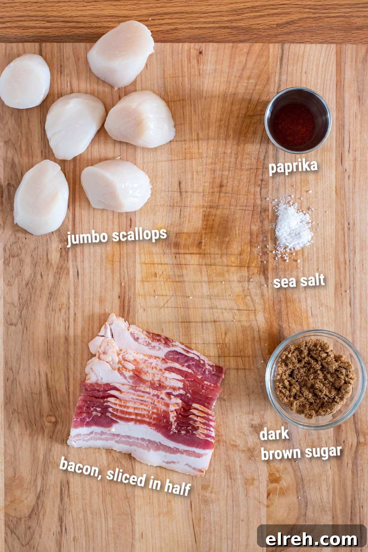 Sweet and Smoky Bacon Wrapped Scallops 3 Raw ingredients for bacon wrapped scallops on a wooden cutting board.