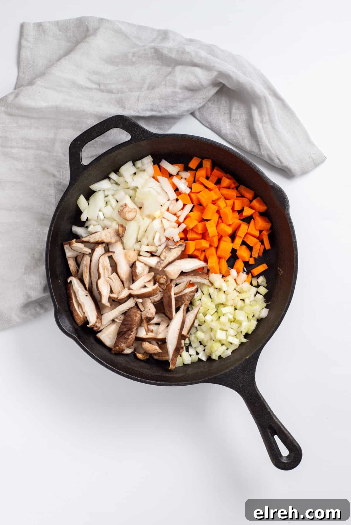 Classic Vegan Stuffing with Herbs and Cranberries 5 Overhead view showing skillet with onions, carrots, celery and shiitake mushrooms.