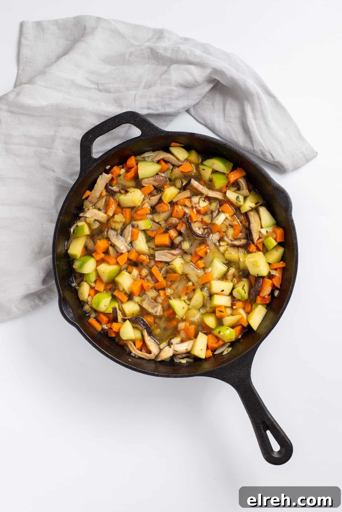 Classic Vegan Stuffing with Herbs and Cranberries 7 Overhead view showing broth added to skillet.