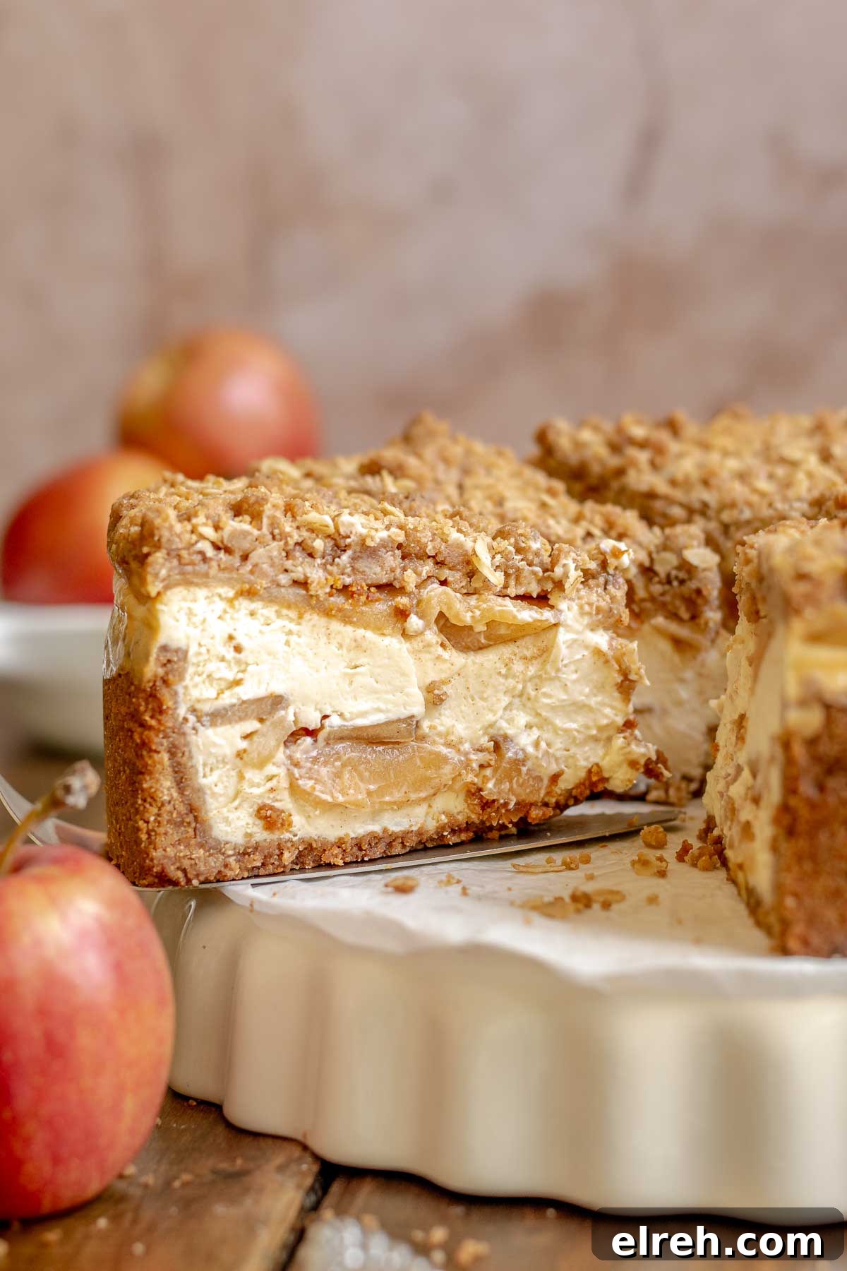 Apple Crumble Cheesecake with Cinnamon Streusel Recipe 2 Apple crumble cheesecake cut on a platter.