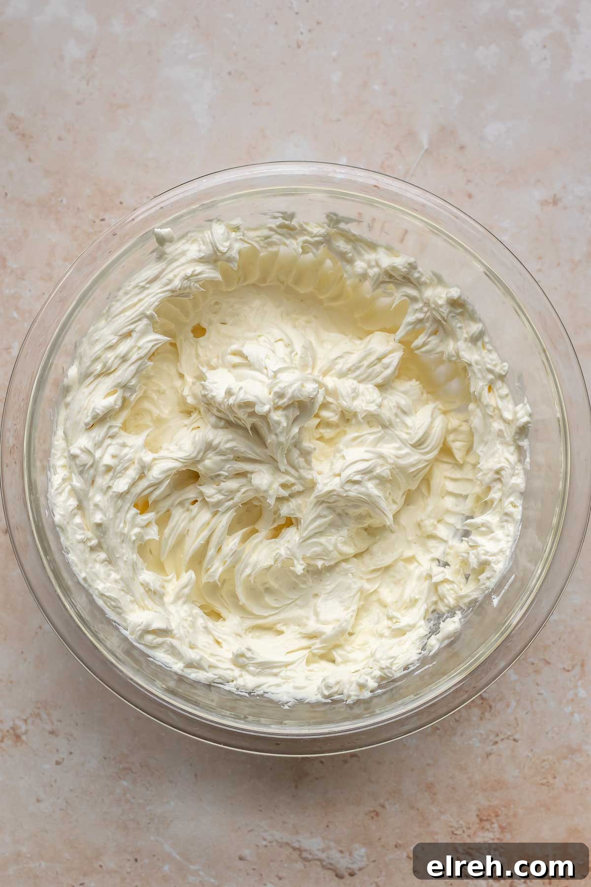 Apple Crumble Cheesecake with Cinnamon Streusel Recipe 11 Cream cheese whisked in a mixing bowl.