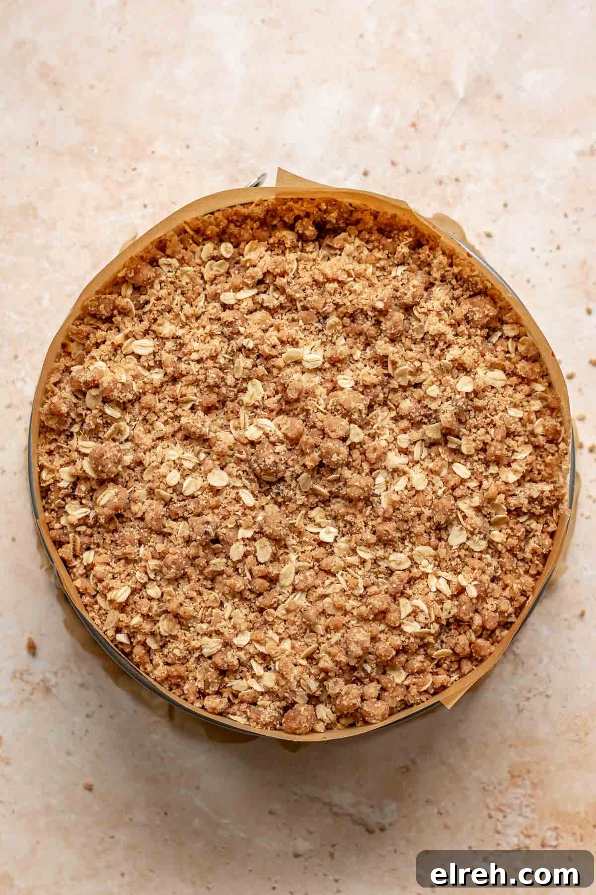 Apple Crumble Cheesecake with Cinnamon Streusel Recipe 19 Crumble topping on top of cheesecake batter.