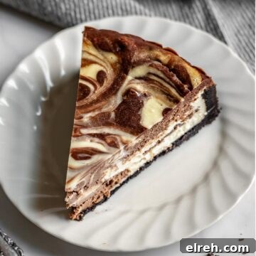Apple Crumble Cheesecake with Cinnamon Streusel Recipe 21 Slice of chocolate marble cheesecake on a plate.