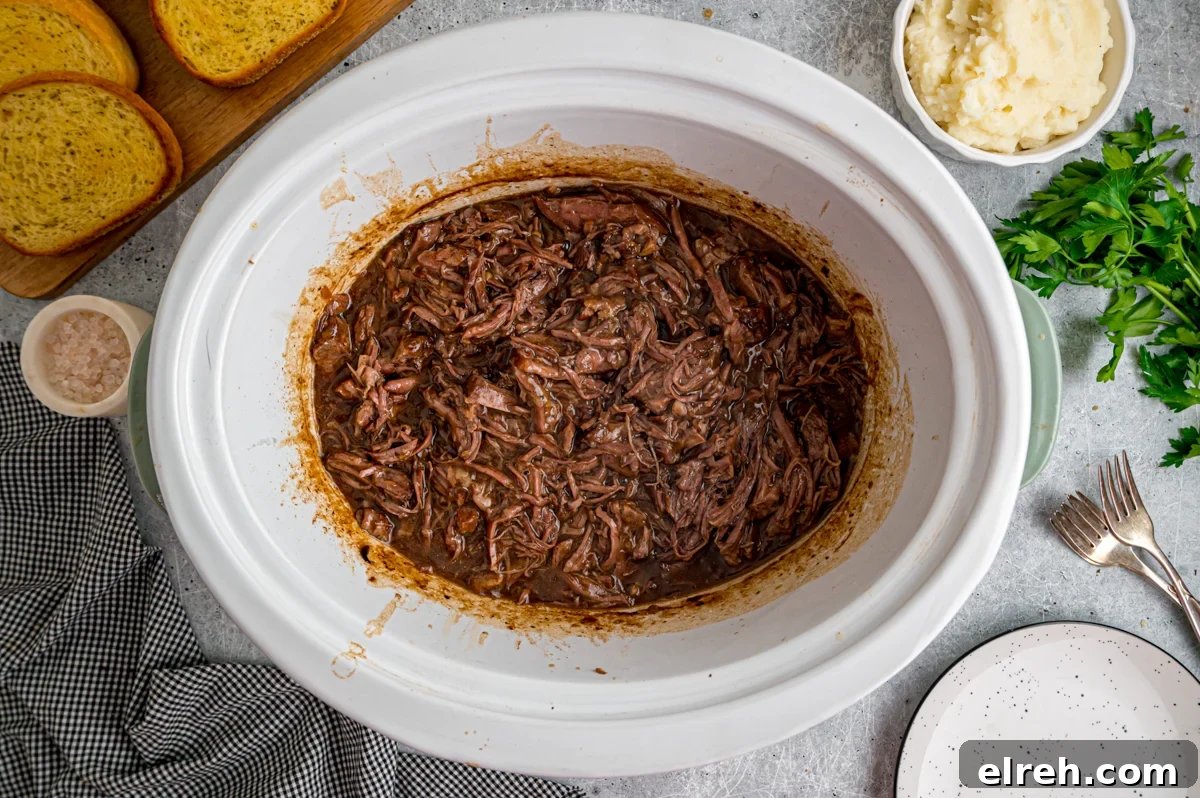Open Faced Roast Beef Manhattan Sandwich with Gravy 7 Cooked and shredded beef in a crockpot.