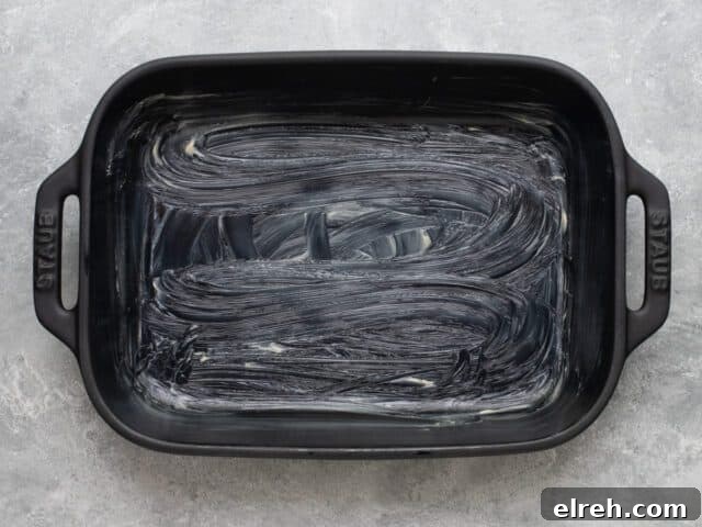 Greased baking dish for sausage quiche squares.