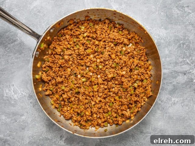 A skillet with chorizo sausage for making spicy quiche squares.
