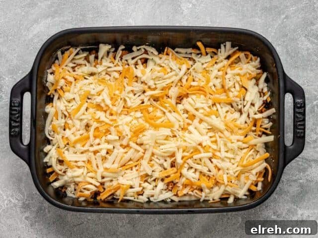 Layers of chorizo and cheese for sausage quiche squares.