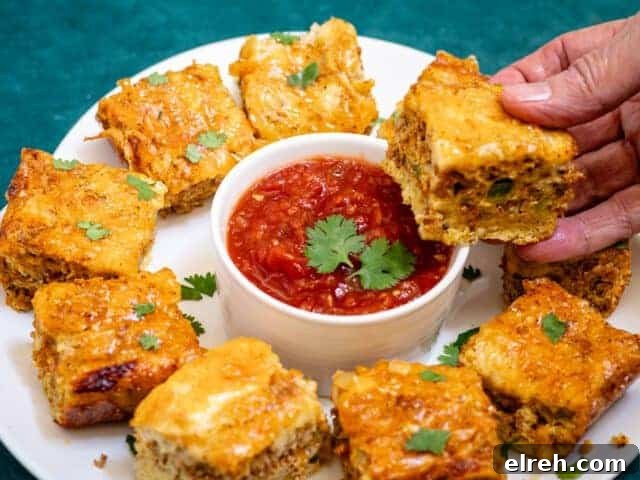Chorizo quiche squares on a platter with salsa and cilantro.