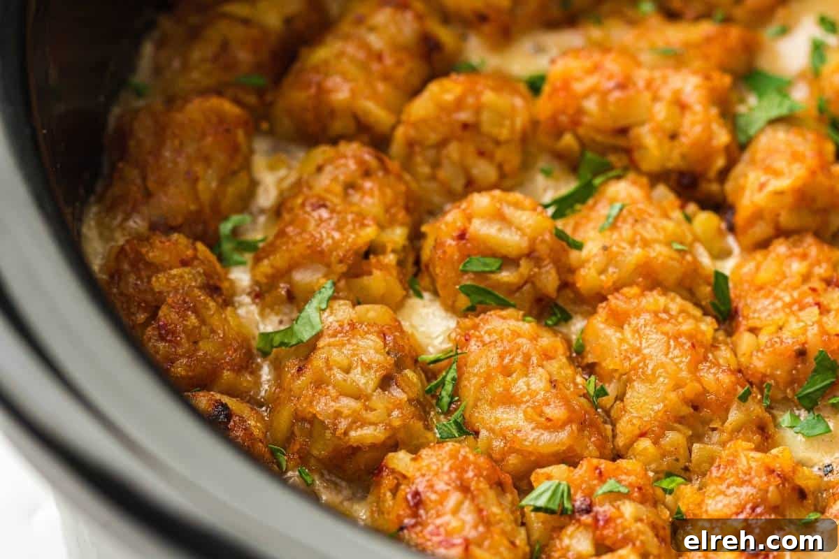 Close-up of Slow Cooker Cowboy Casserole garnished with chopped parsley, inside a slow cooker.