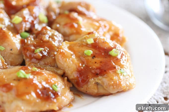 Apple Juice Glazed Chicken Thighs Recipe 2 Close-up of a plateful of chicken with a thick, syrupy sauce.
