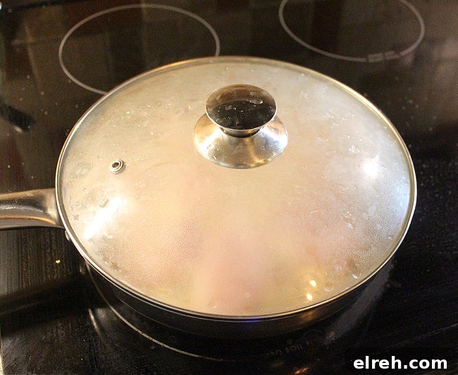 Apple Juice Glazed Chicken Thighs Recipe 6 Covered pan on a black stove.