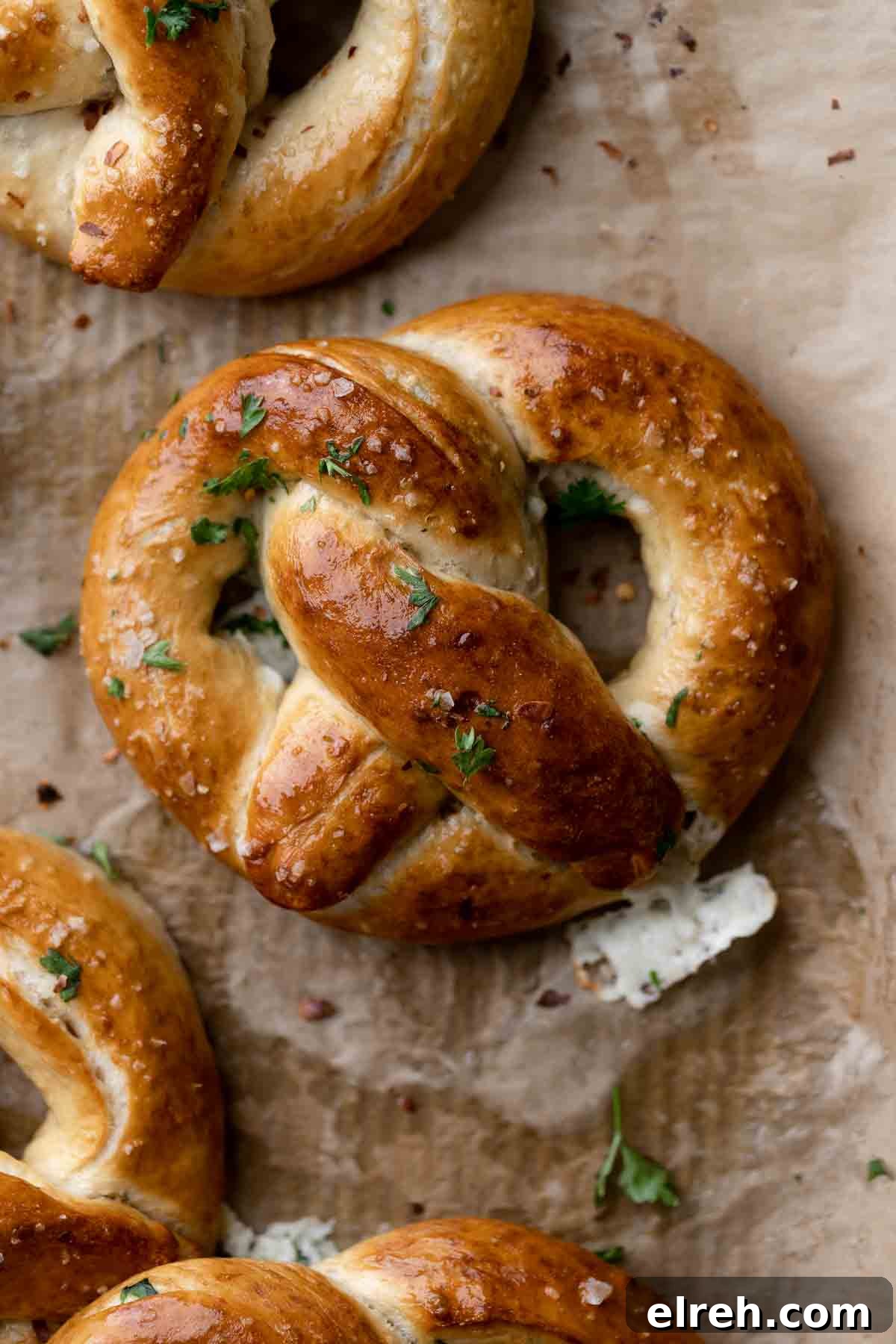 stuffed pretzels on a parchment lined baking tray.