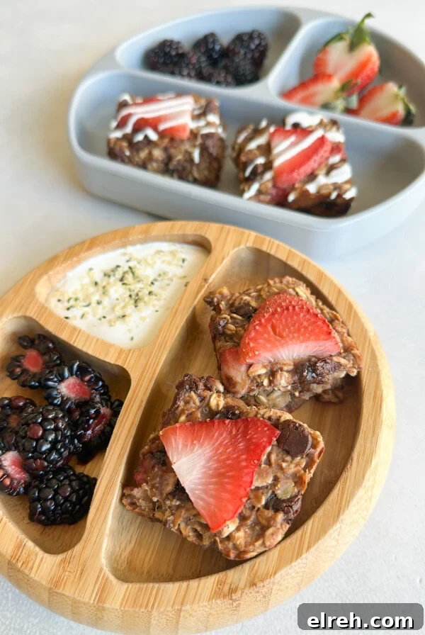Strawberry banana oat bars served with berries and yogurt.