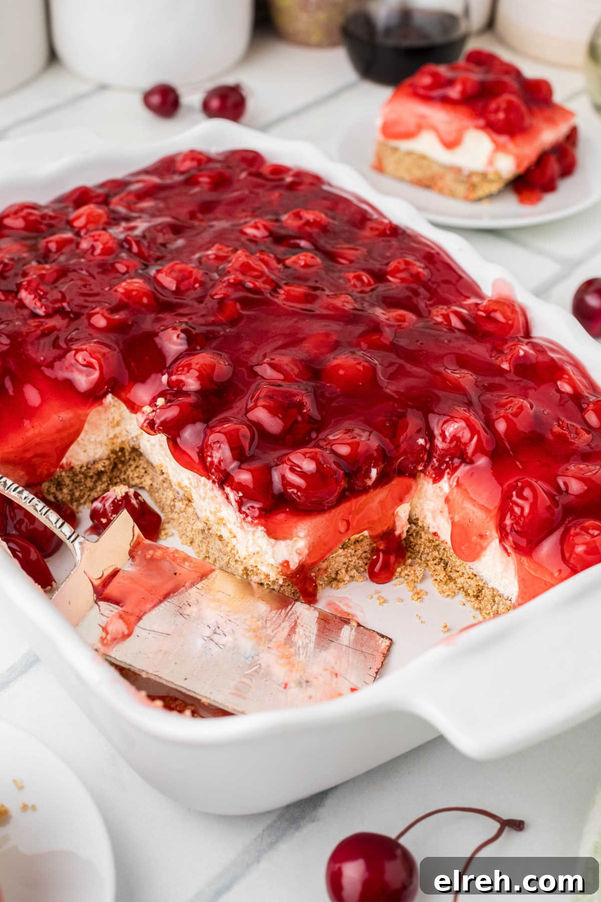 Shot of the inside of a dish with cherry delight, with some sections missing already.