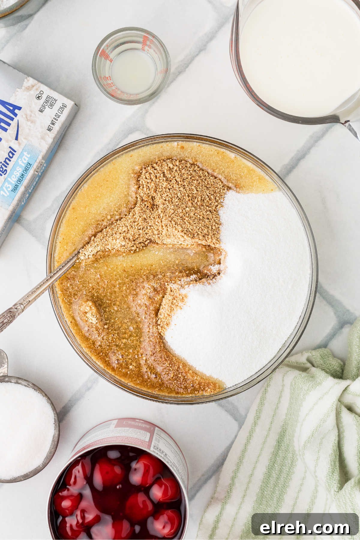 A large mixing bowl full of melted butter, crumbs and sugar.