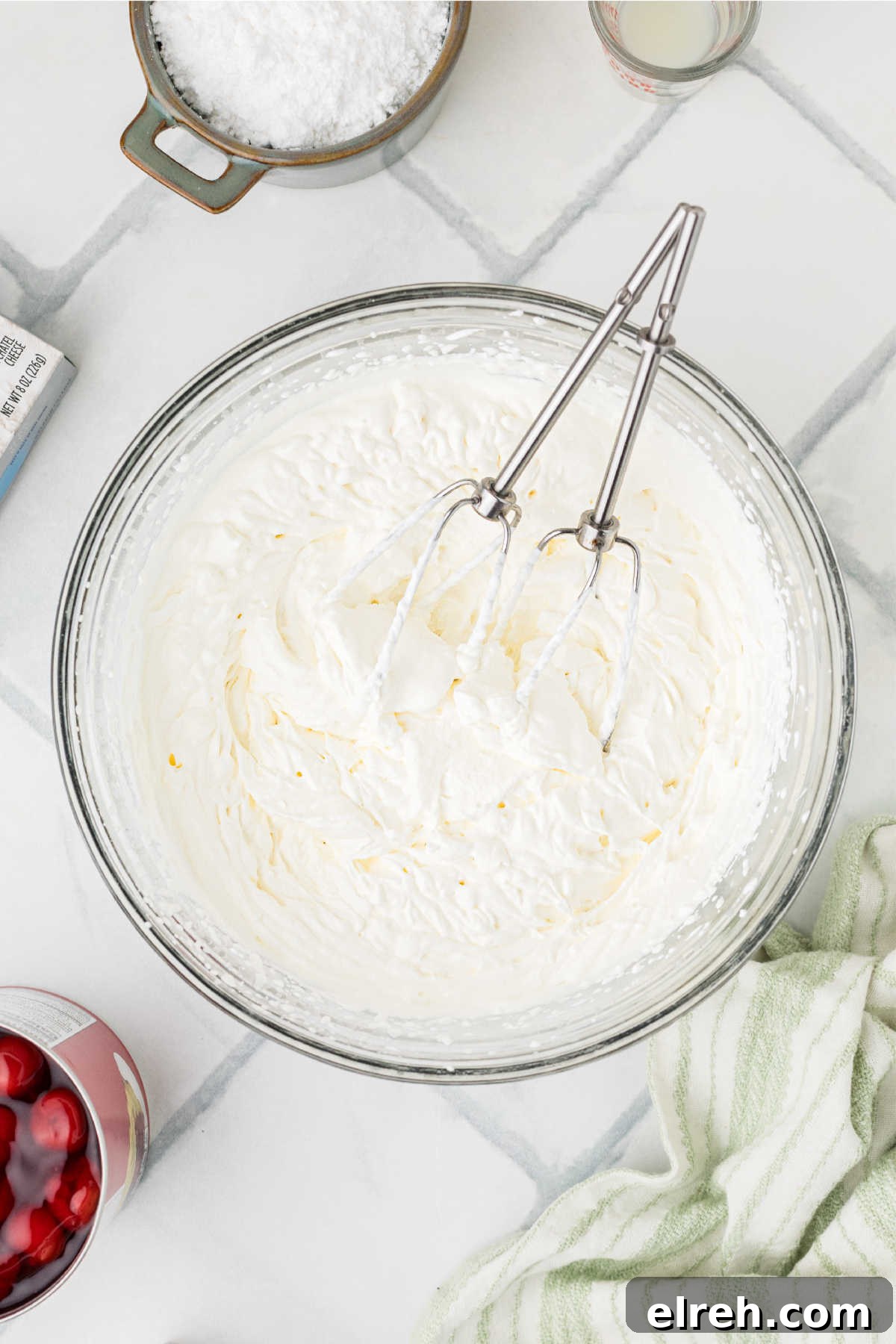 A large mixing bowl with cream whipped up.
