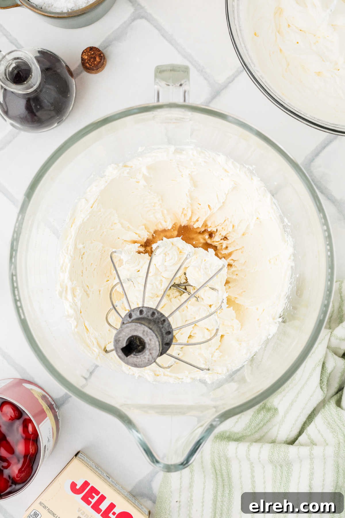 Whipped cream being mixed with vanilla and pudding mix.