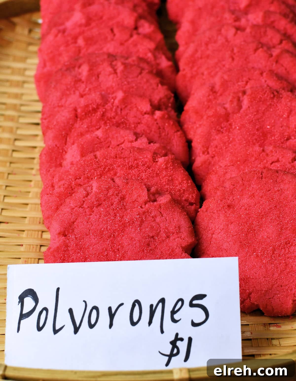 a displayed basket of Mexican Pink Cookies with a one dollar price polvorones rosas