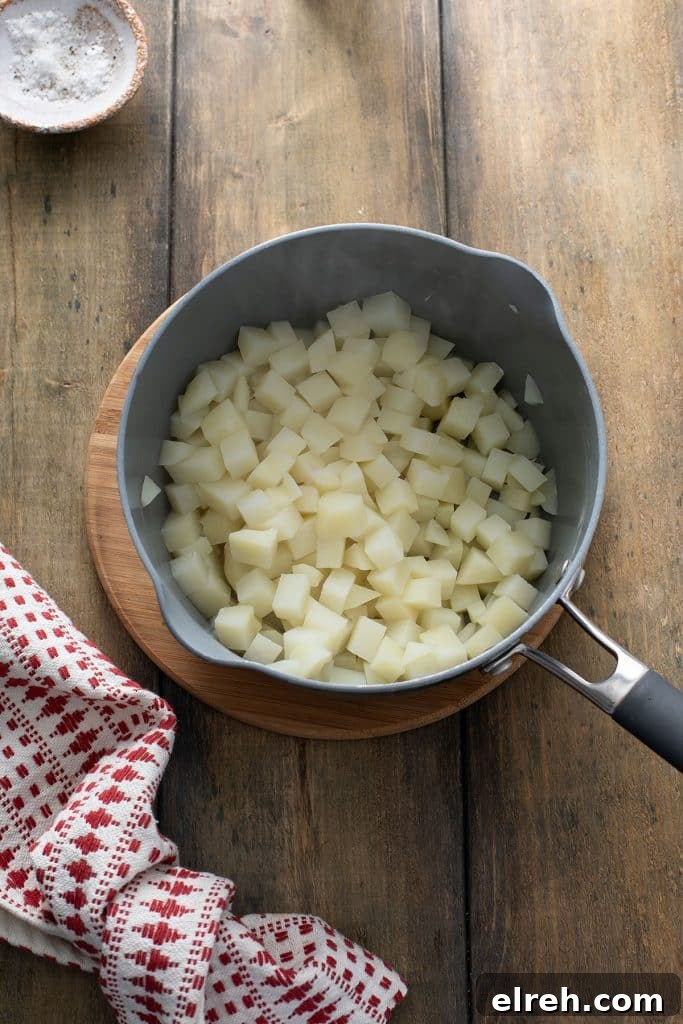 Diced potatoes that have been boiled in a pot.