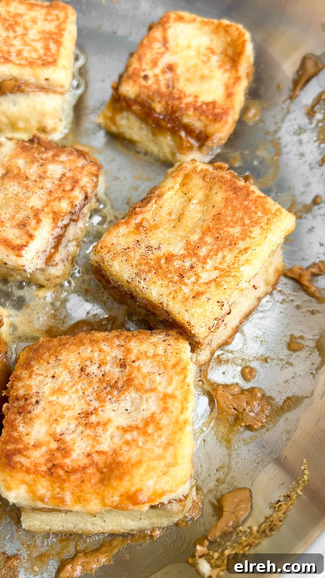 Cream Cheese Stuffed French Toast Bites with Maple Syrup 9 french toast bites in a pan
