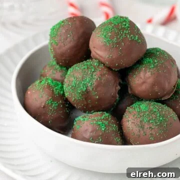 Round white dish of Chocolate Peppermint Truffles, sitting on a round white plate.