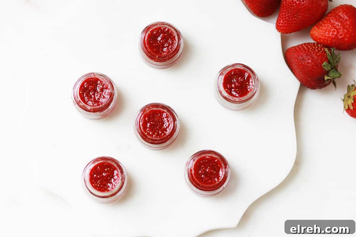 glass lip balm containers filled with homemade strawberry lip balm