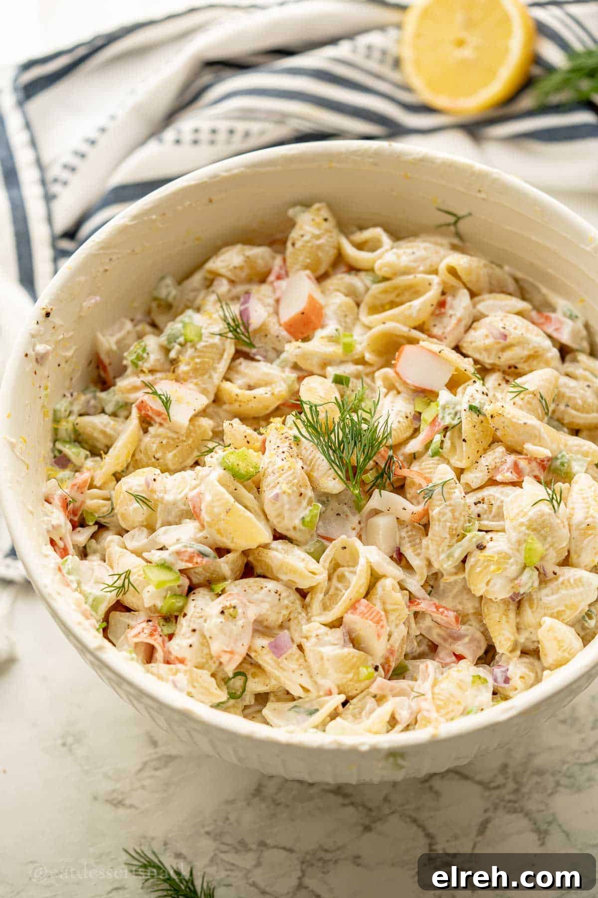 Creamy Crab and Pasta Salad with Lemon Dill Dressing 2 Creamy crab salad with dill on top.