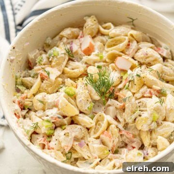 Creamy Crab and Pasta Salad with Lemon Dill Dressing 10 Creamy crab pasta salad with dill on top.