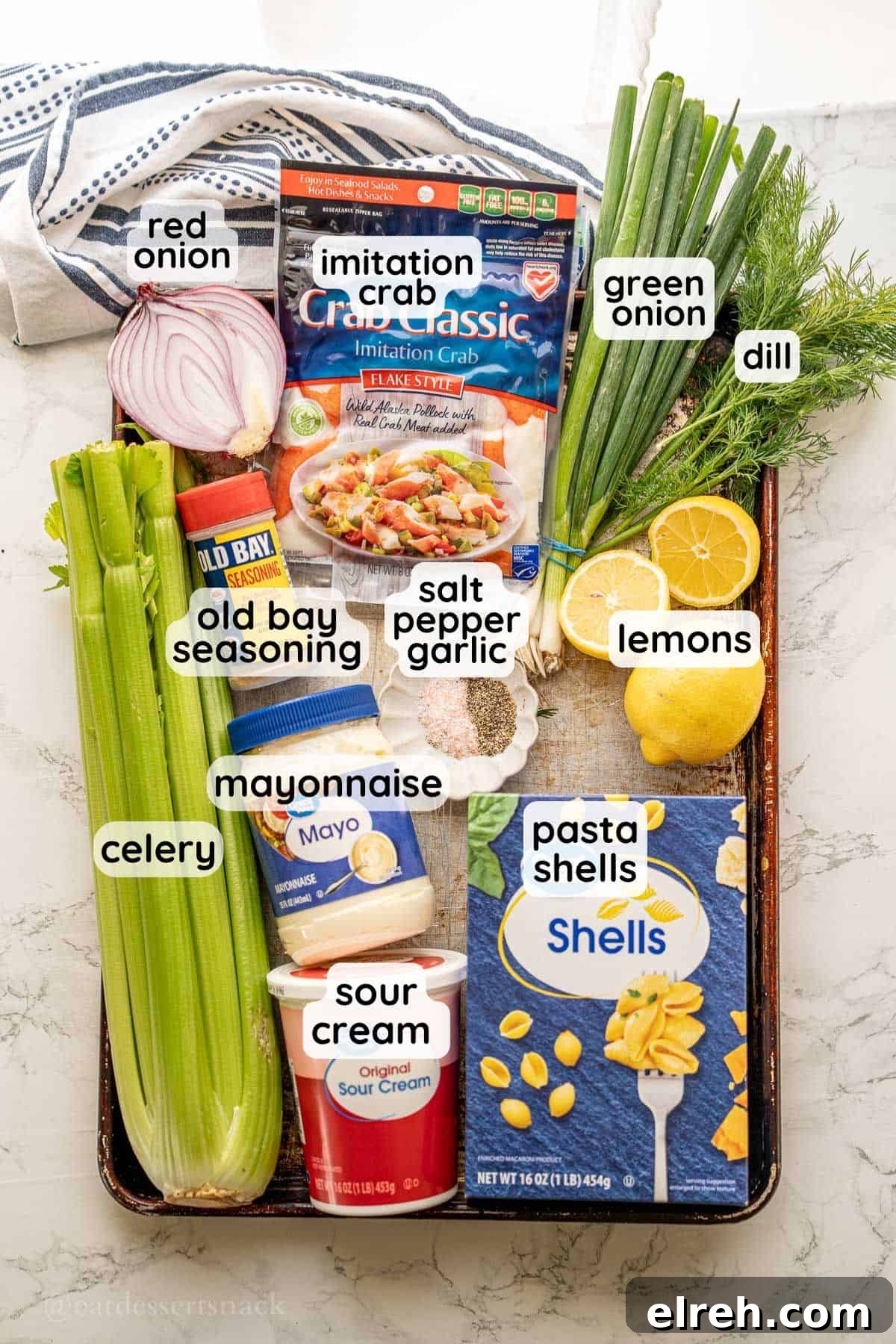 Creamy Crab and Pasta Salad with Lemon Dill Dressing 3 Labeled ingredients for crab salad on baking sheet.
