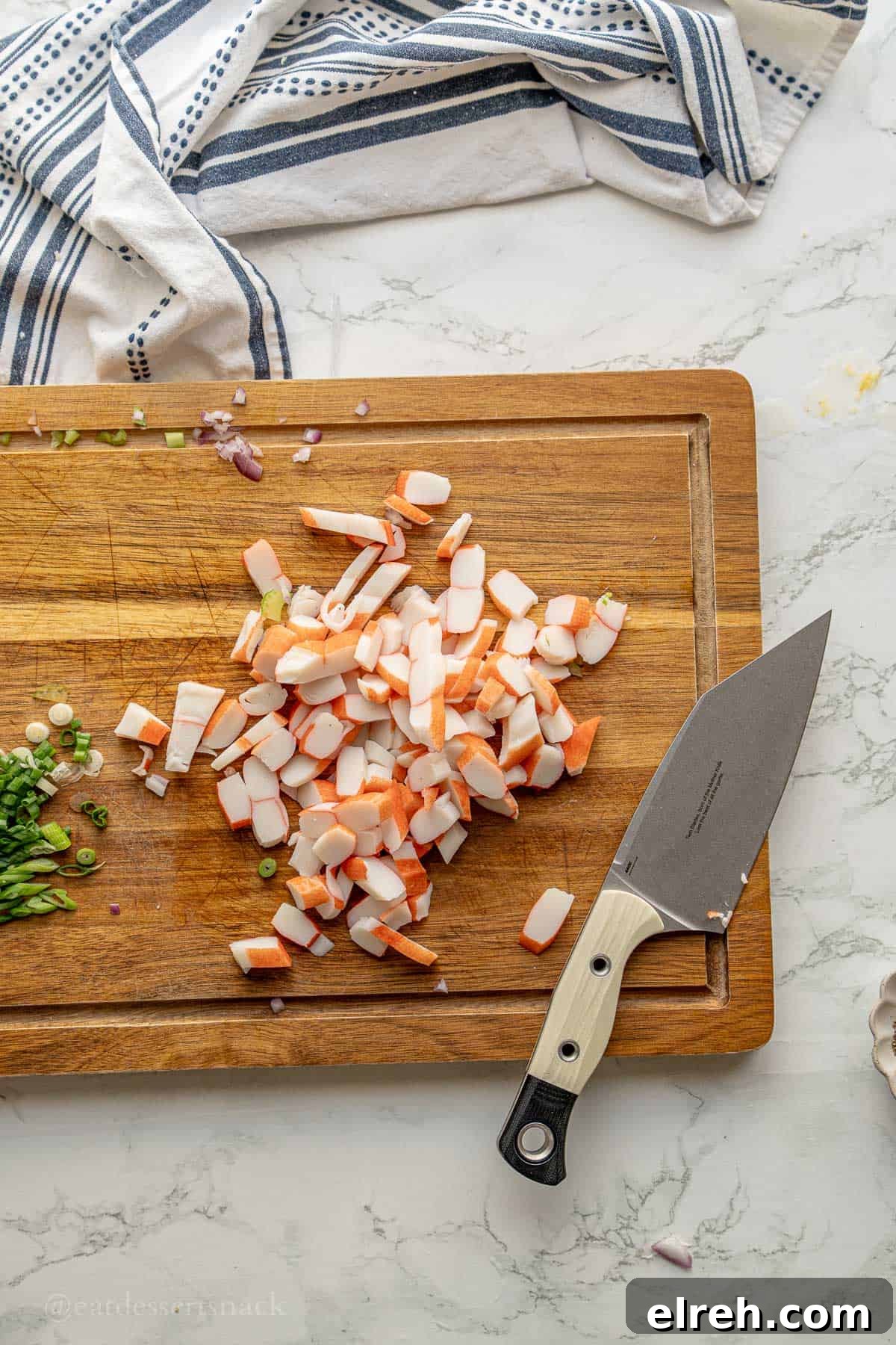 Creamy Crab and Pasta Salad with Lemon Dill Dressing 6 Imitation crab chopped on wood cutting board.