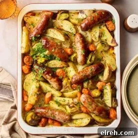Simple sausage tray bake with carrots potatoes and leeks, all on one tray.