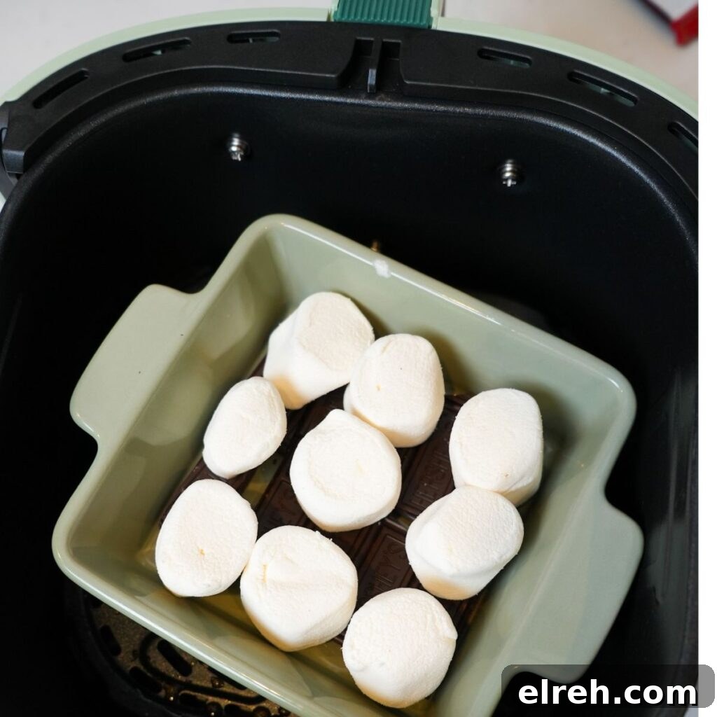 Chocolate pieces arranged in a small oven-safe dish before adding marshmallows.
