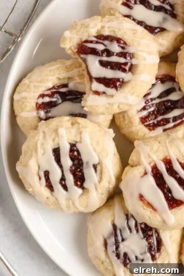 Gluten-free raspberry thumbprint cookies on a plate.