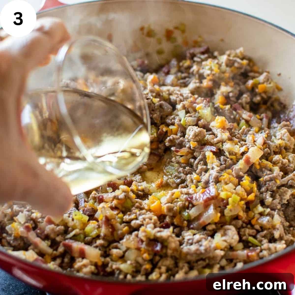 Authentic Tagliatelle with Bolognese Sauce Recipe 6 White wine being poured into browned ground meat.