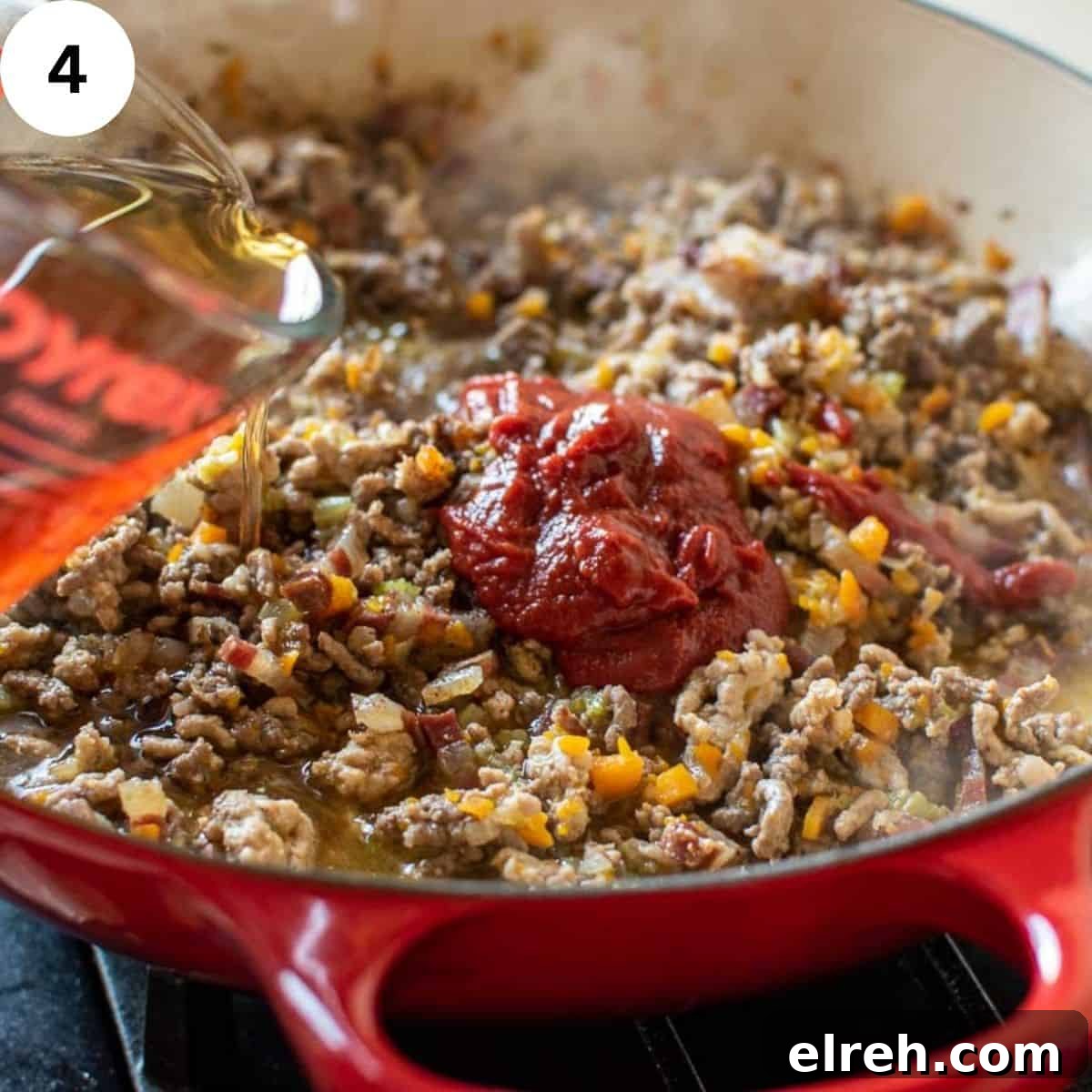 Authentic Tagliatelle with Bolognese Sauce Recipe 7 Beef stock being added to browned ground meat.