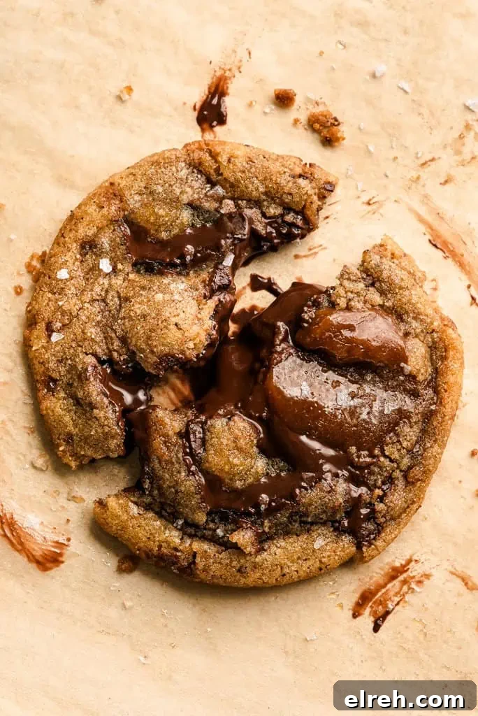 brown butter cookie split in half on parchment paper