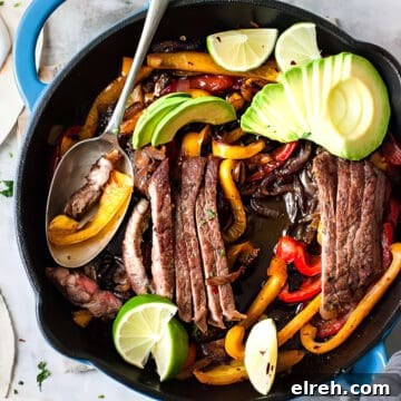 Steak fajitas with peppers and avocado in soft flour tortillas.
