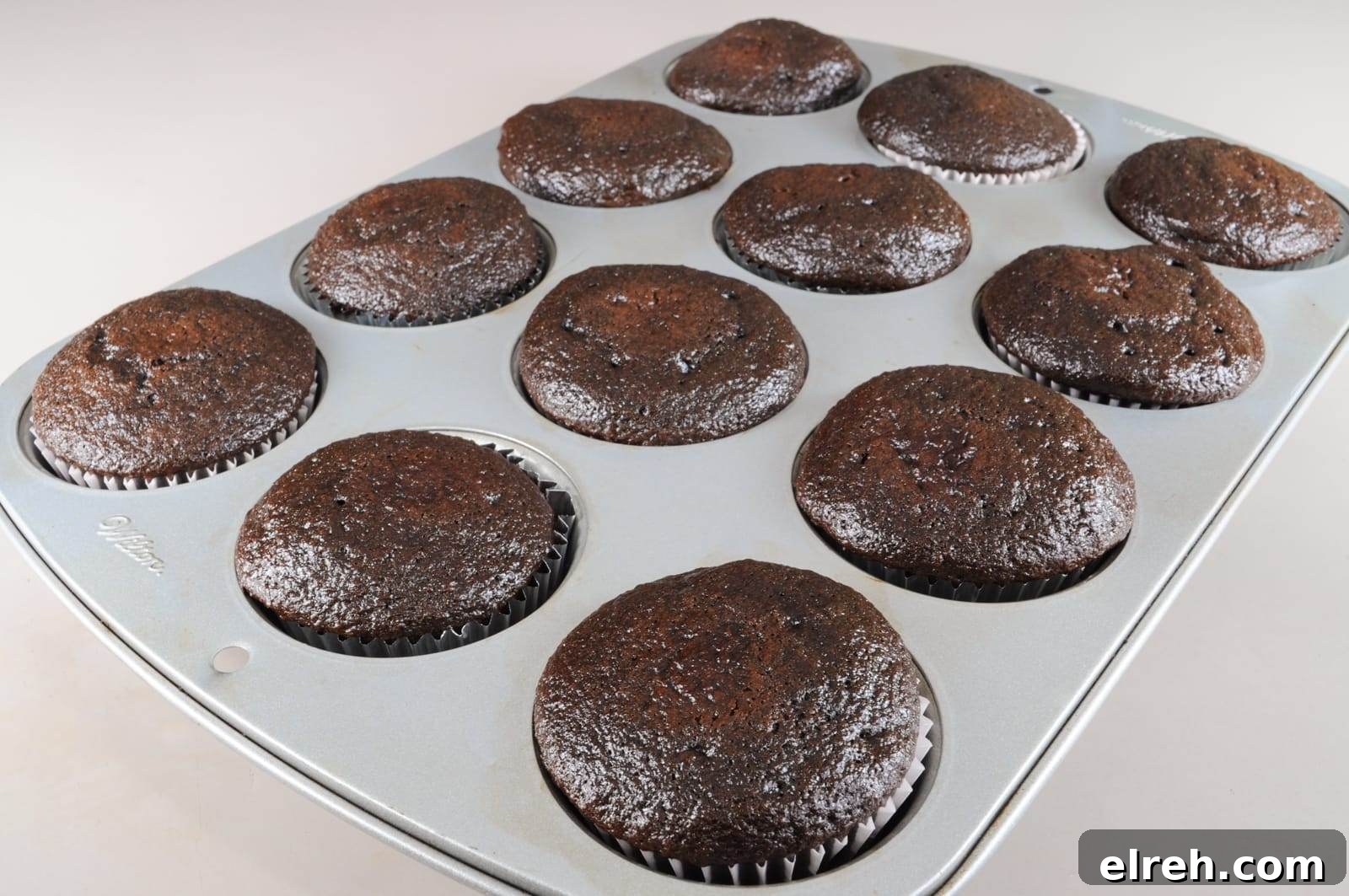 Baked chocolate cupcakes ready for frosting