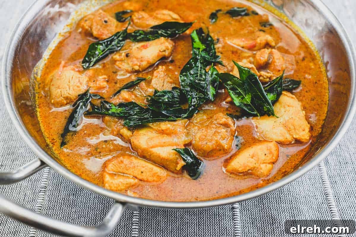 Achari Chicken in a silver serving bowl