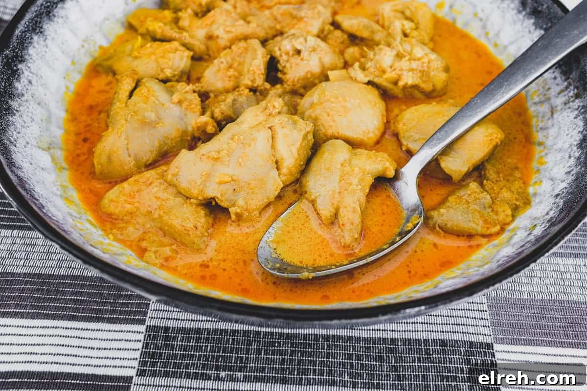 Chicken cooked in coconut milk with Malaysian aromatics to make Nyonya Chicken Curry (Ayam Kleo)