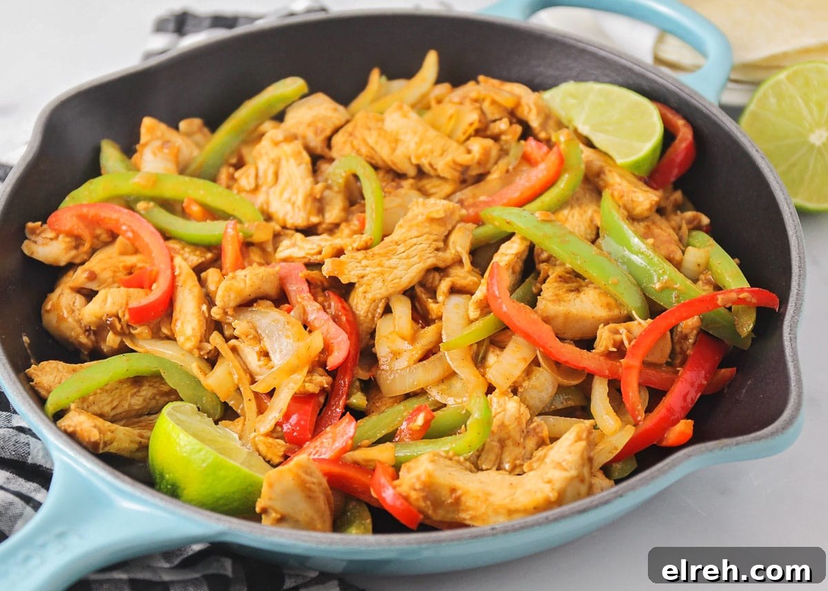 Chicken fajitas in skillet made with homemade fajita marinade recipe.