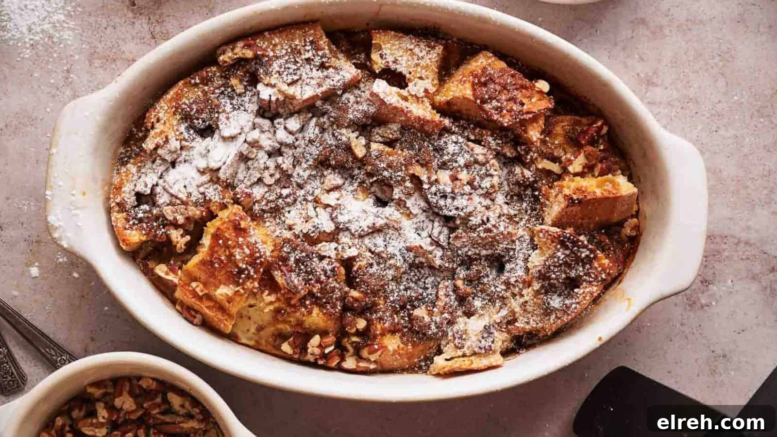 A person taking a portion of French toast casserole.
