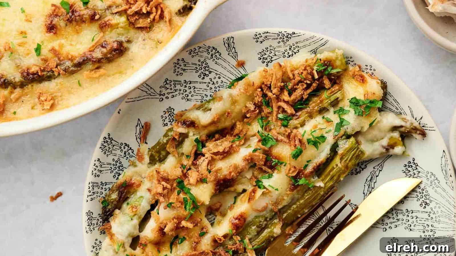 Cheesy asparagus casserole on a plate with a fork.