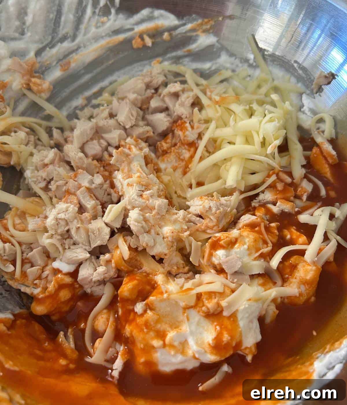 Creamy High-Protein Buffalo Chicken Dip with Cottage Cheese 6 Buffalo chicken dip ingredients in bowl.