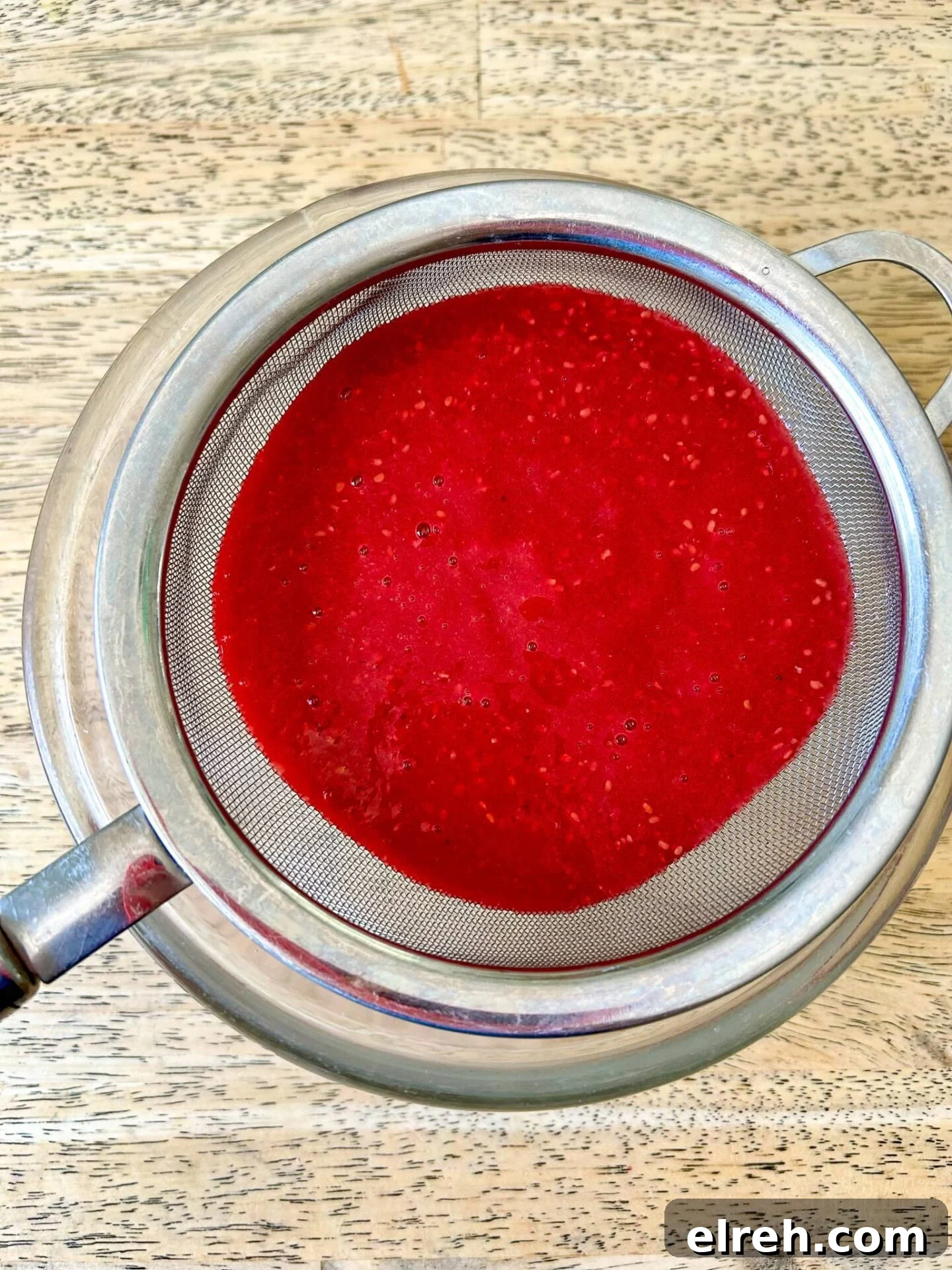 2-Ingredient Raspberry Coulis Recipe for Cakes and Ice Cream 3 Raspberry coulis drizzled on dessert