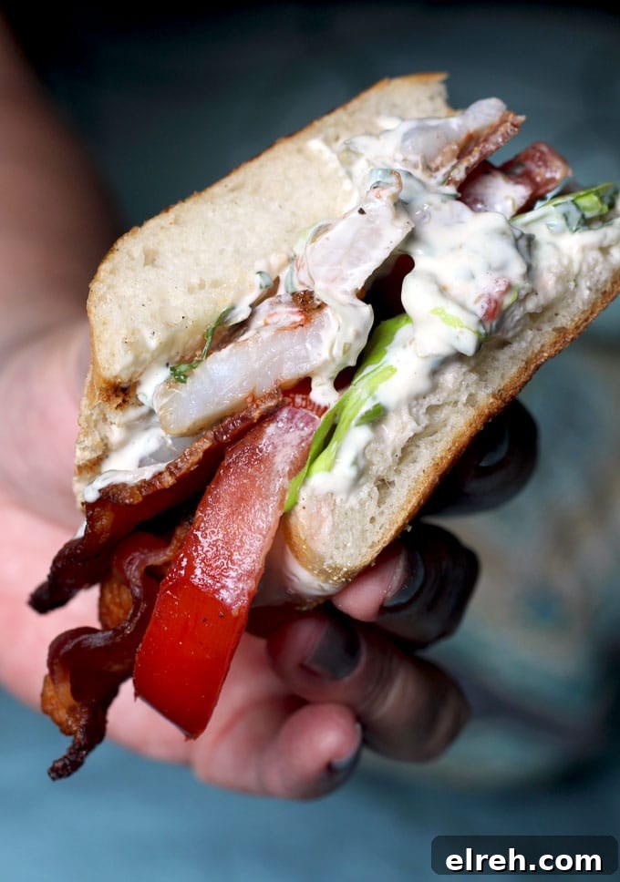 close up of a blt panini with grilled shrimp and creamy herb aioli